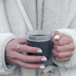 a woman holding a glass of wine in her hands