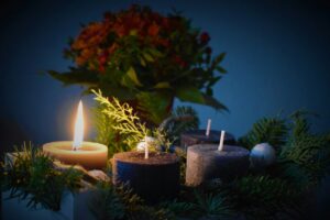 lighted candle beside another 3 candles