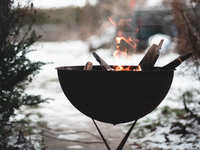 a bbq grill with a fire burning in it