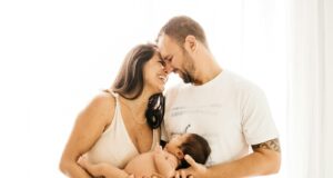 man in white crew neck t-shirt kissing woman in white dress