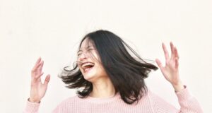 smiling woman wearing pink sweater