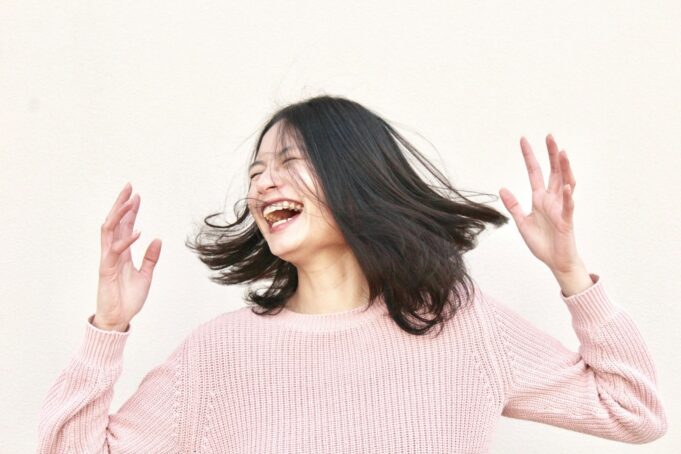 smiling woman wearing pink sweater