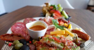 A delicious charcuterie board with a variety of snacks.
