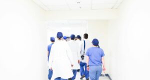 group of doctors walking on hospital hallway
