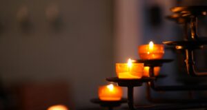 lighted candles on black metal candle holder
