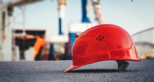 red hard hat on pavement
