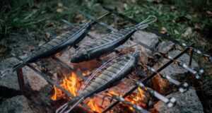 three gray fish on grill