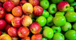 green and red apples on white plastic container