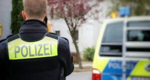 a police officer standing in front of a police car