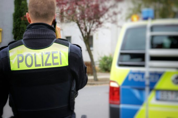 Photo by (Augustin-Foto) Jonas Augustin a police officer standing in front of a police car