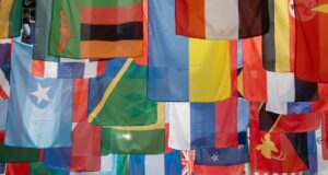 a bunch of flags hanging from a pole
