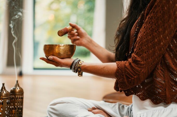 Photo by THLT LCX woman in brown knit sweater holding brown ceramic cup