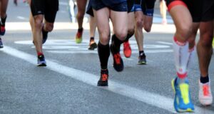 people running on gray asphalt road during daytime