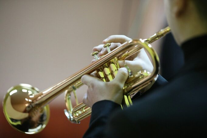 Photo by Gruescu Ovidiu a person playing a trumpet