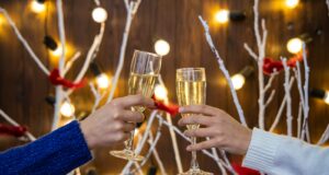 person holding wine glasses with red liquid