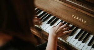 woman playing Yamaha piano