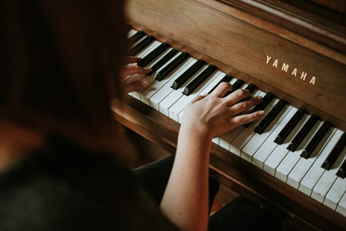 Photo by Jordan Whitfield woman playing Yamaha piano