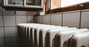 white radiator heater beside brown wooden window