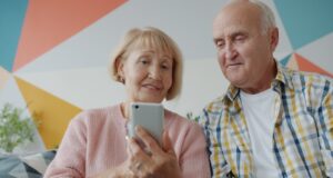 Elderly couple looking at a smartphone together on phone