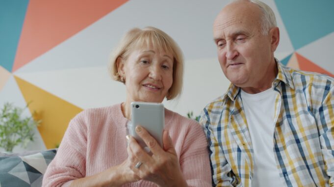 Photo by Vitaly Gariev Elderly couple looking at a smartphone together on phone